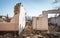 Remains of hurricane or earthquake aftermath disaster damage on ruined old houses with collapsed roof and wall