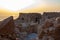 The remains  of internal buildings in the rays of the rising sun in the ruins of the fortress of Masada - is a fortress built by