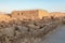 The remains  of internal buildings in the rays of the rising sun in the ruins of the fortress of Masada - is a fortress built by