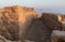 The remains  of internal buildings in the rays of the rising sun in the ruins of the fortress of Masada - is a fortress built by