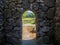 Remains of an old castle. Ancient fortifications made of stone. Museum in the open air. Door in the wall