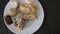 The remains of pastries and cake in a plate on the table. Harmful delicious sweet food. Close-up