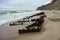 The remains of a ship on the sand, pieces of rusty iron on the seashore