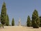 Remains of stone statue of emperor Trajan in between trees on trajano viewpoint in Italica