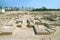 Remains of the Structure of Bahrain Fort or Qal`at al-Bahrain with Manama Modern Cityscape in the Backdrop, Bahrain