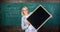 Remember this information. Teacher smart smiling woman hold blackboard blank advertisement copy space. School schedule