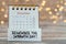 Remember Sabbath Day, handwritten quote with calendar on wooden table with bokeh background