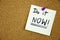 A reminder to do it now message, Bulletin board with a blue sticky note with text Do it Now