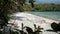 Remote beach with white sand partially framed by tree branches