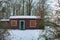 Remote cabin in snowy countryside.