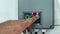 Remote control of opening roller shutters. A man presses the button. close-up