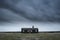 Remote desolate isolated house under dark stormy sky during Wint