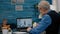 Remote doctor using webcam prescribing medicine to sick aged man