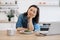 Remote employee sitting at table with laptop and salad