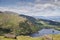 A remote and empty country side Irish road in county Kerry, with green fields, a lake,  and distant mountains