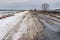 Remote empty road covered with melting snow in Sumskaya oblast, Ukraine
