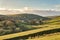 Remote farm buildings hidden in a valley.