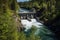 remote hydroelectric power plant, surrounded by lush greenery and clear waters