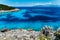 Remote lagoon with pure crystal clean turquoise sea water, surrounded by cypress trees and white rocks