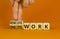 Remote or onsite work symbol. Businessman turns cubes and changes words `onsite work` to `remote work`. Beautiful orange