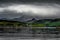 Remote Settlement Near Gairloch In Front Of Mountains With Fog And Rain Clouds At The Scenic Coast Of Scotland