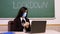 Remote teaching, lockdown at schools. Online schooling, e-learning. Female teacher, in protective mask, is holding