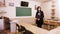 Remote teaching, lockdown at schools. woman teacher, in a protective mask, stands in an empty school classroom with a