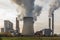 Remote view of a brown coal power plant with its cooling towers and chimneys