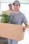 removals men carry cardboard boxes