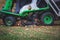 Removing fallen autumn leaves in the park, process of raking and cleaning the area from yellow leaves, regular seasonal work with