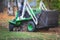 Removing fallen autumn leaves in the park, process of raking and cleaning the area from yellow leaves, regular seasonal work with