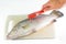 Removing fish scales using fish scaler.