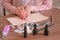 Removing gel Polish from nails. Woman removes shellac from nails with pusher. Close-up hand.