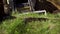 Removing layer of grassy soil by bulldozer bucket during earth works