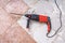 Removing old tiles. Jackhammer - drilling demolition hammer on floor