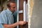 Removing the protective tape from the door,a man removes masking tape from a new door that has just been installed