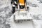 Removing snow accumulations using a tractor with attachments.