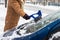 Removing snow from car window on the street