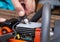 Removing the spark plug from the chainsaw cylinder. Replacing a new spark plug, a malfunction in the ignition of the fuel. Close-