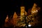 Renaissance architecture castle lighted by night, silhouetted tree in the foreground