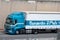 Renault Premium loaded truck a white container trailer along Barcelona's Ronda Litoral