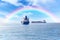 Rendezvous of two ships on the high seas. Commercial container ship on the high seas. Rainbow after rain