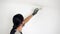 renovate the walls of the home. man applying paint to a wall.