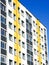 Renovated and insulated multistorey apartment building against a blue sky background