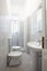 Renovated narrow bathroom with gray cement tiles