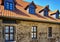 Renovated tiled roof with dormer windows on old brickwork