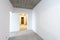 Renovation home. Building construction interior site with clean white concrete room walls, electric light corridor under