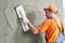 Renovation. Plasterer putting plaster on wall.