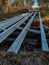 Renovation of a small old bridge. Steel girders painted and in good condition lying on rotten and rotten wooden sleepers