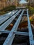 Renovation of a small old bridge. Steel girders painted and in good condition lying on rotten and rotten wooden sleepers